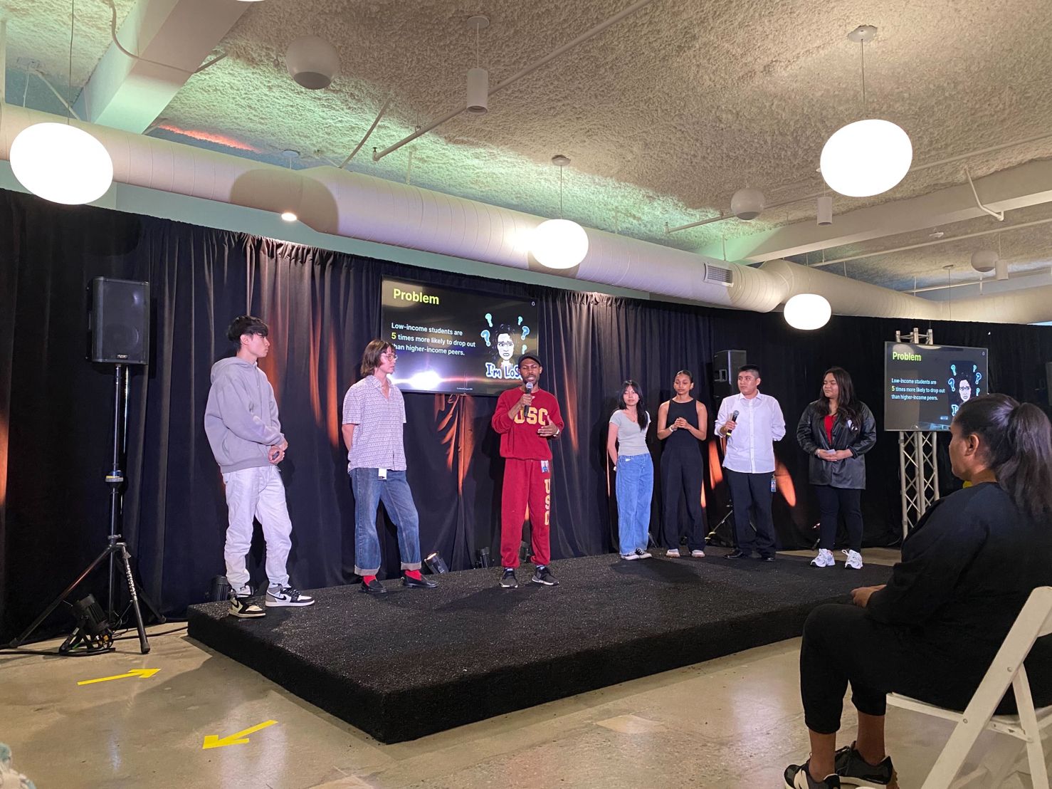 Photo of myself and my group on stage presenting our feature during rehearsals for Final Showcase.