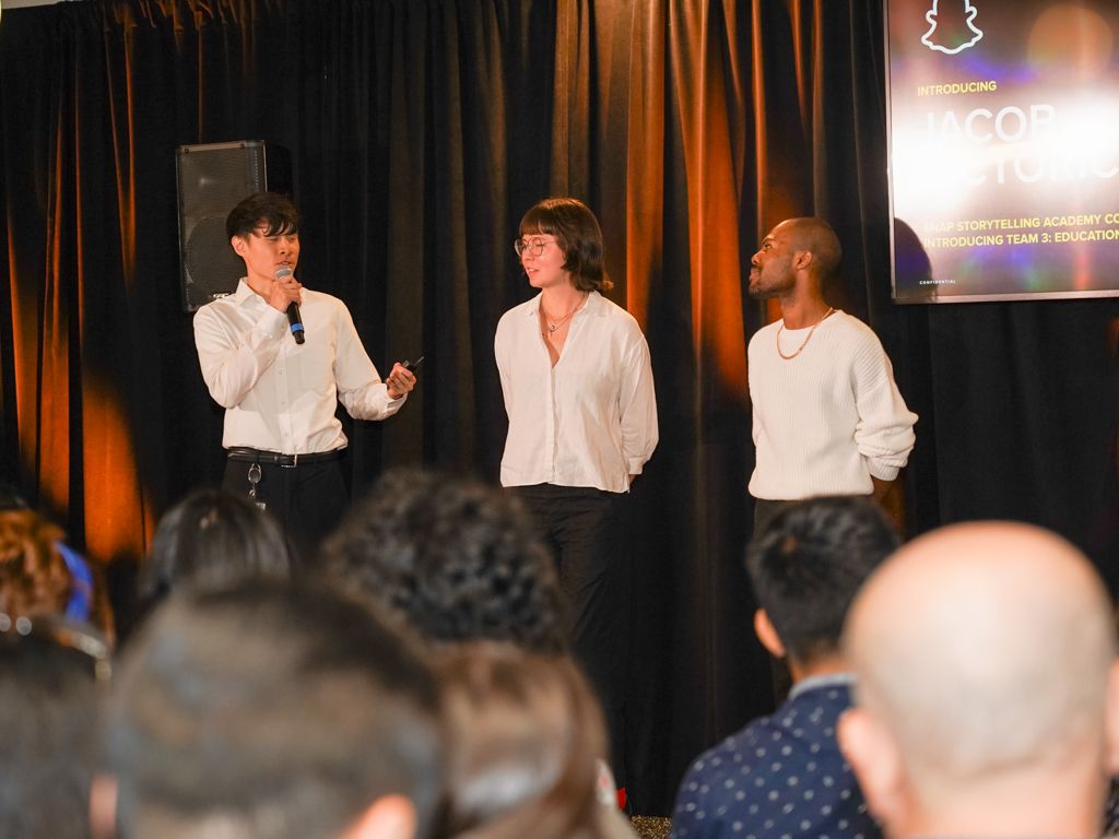 Photo of myself and my group on stage presenting our feature during the official Final Showcase.